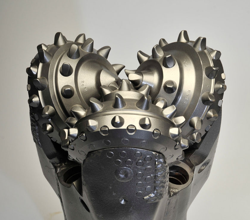 Front view of TCI tricone drill bit with sealed bearing and tungsten carbide insert cutters.