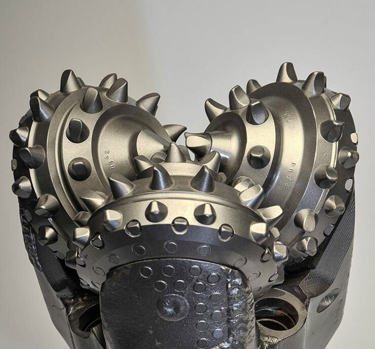 Front view of TCI tricone drill bit with sealed bearing and tungsten carbide insert cutters.