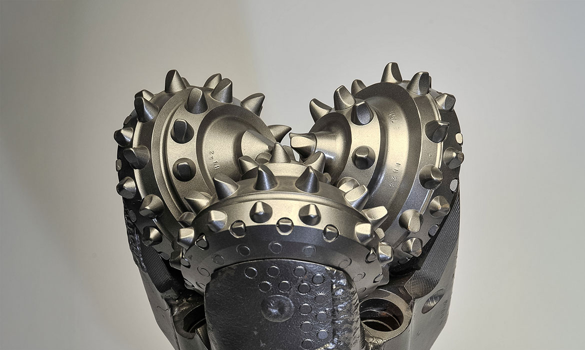 Front view of TCI tricone drill bit with sealed bearing and tungsten carbide insert cutters.