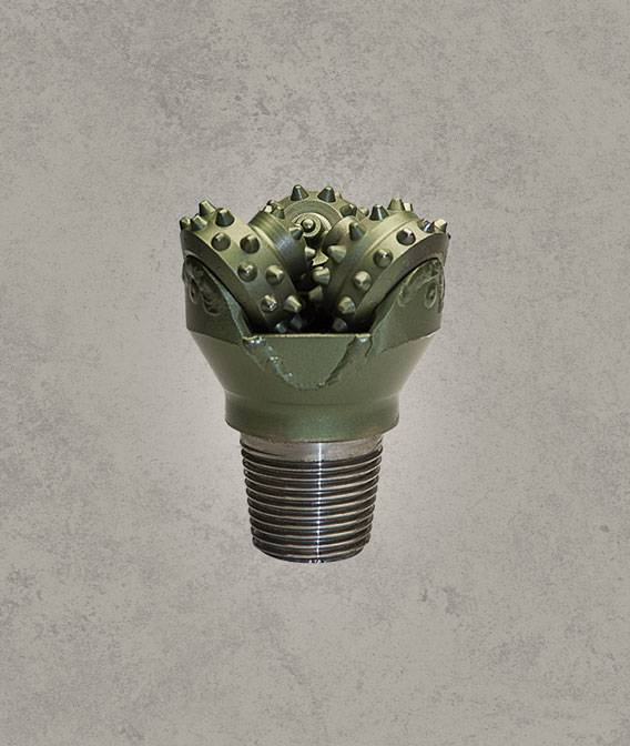 Green tricone rock drill bit with threaded pin connection.