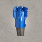 Front view of blue PDC drill bit with polycrystalline diamond cutters and threaded connection.