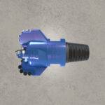 Blue PDC drill bit with diamond cutters and threaded shank.