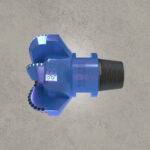 Side view of blue PDC drill bit with cutting blades and threaded connection.