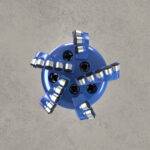 Front view of blue PDC drill bit with multiple polycrystalline diamond cutters.