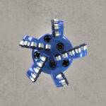 Angled front view of blue PDC drill bit with multiple polycrystalline diamond cutters.