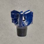 Steel drag drill bit with three blades for soft formation drilling.
