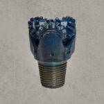 Mill tooth tricone drill bit with open bearing and steel milled teeth.