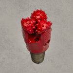 Red TCI tricone drill bit with open bearing and tungsten carbide insert cutters.